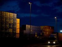 Night Falls but Global Trade Goes On : Containers Piled High and Leaving by Road : Felixstowe Docks : UK